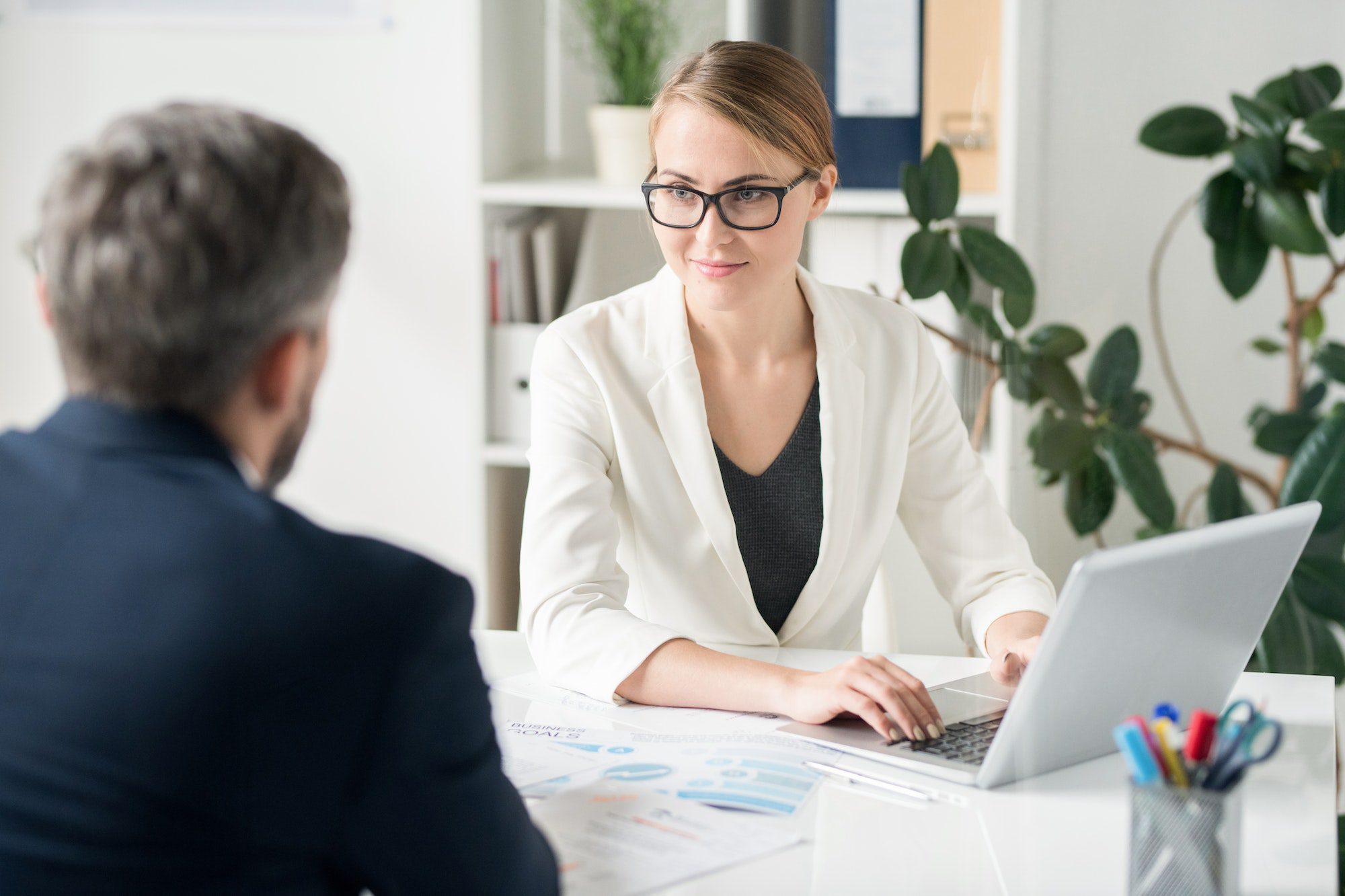 content-attractive-female-business-consultant-working-with-clien.jpg